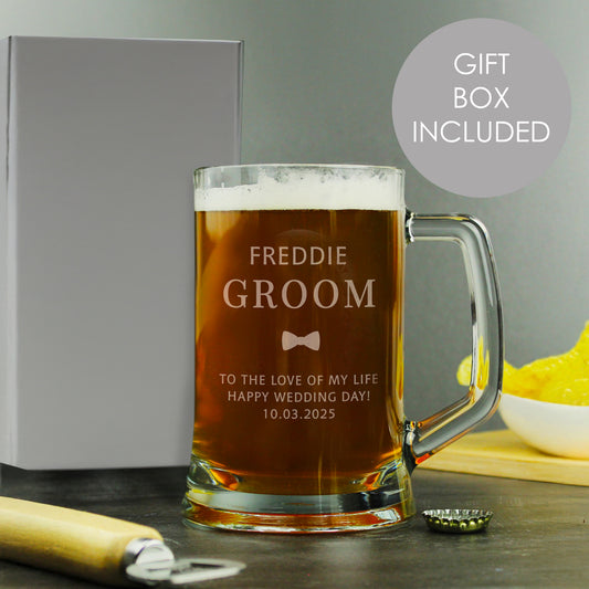 Personalised beer mug with 'Freddie Groom' engraving, gift box included, on a wooden surface.