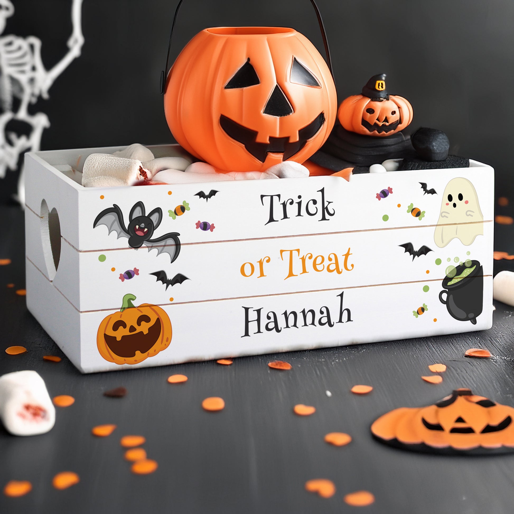 Halloween-themed wooden box with pumpkins and decorative elements on a dark background.
