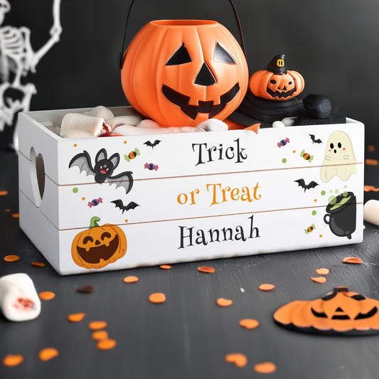 Halloween-themed wooden box with pumpkins and decorative elements on a dark background.