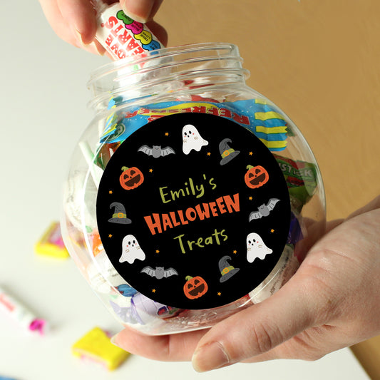 Clear jar labeled 'Emily's Halloween Treats' with colorful candies, held by a hand.