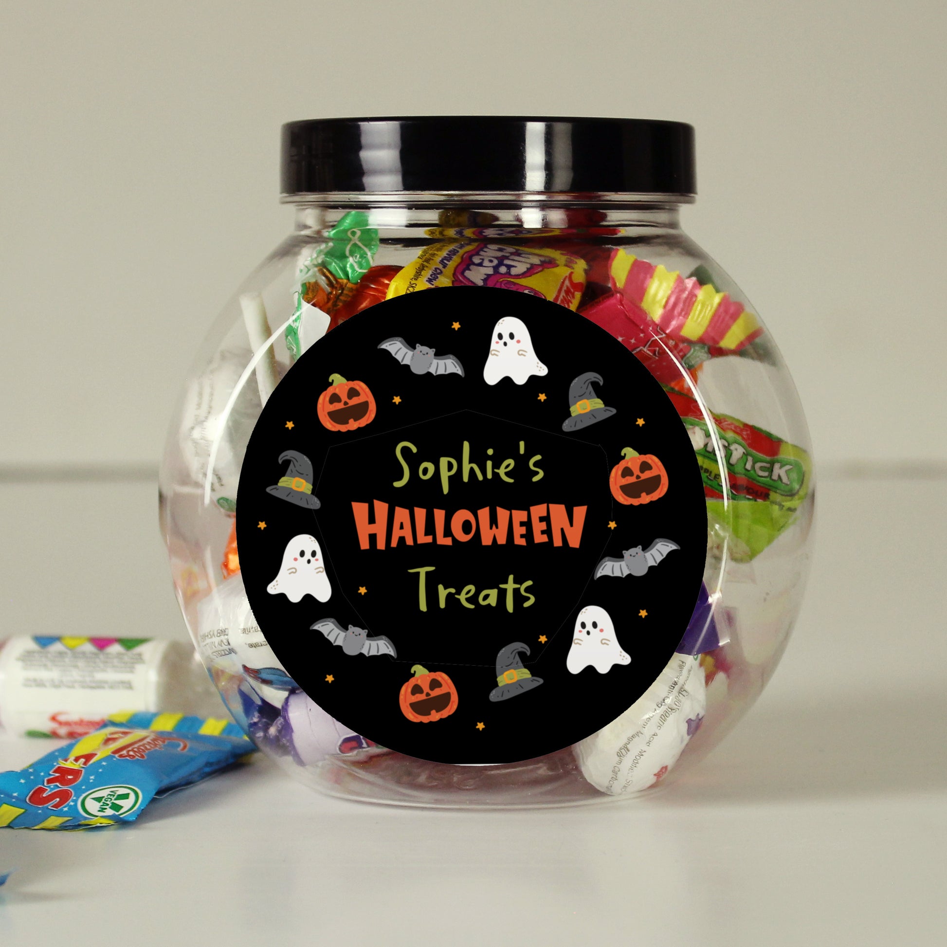 Jar of Halloween treats with a personalised label on a neutral background