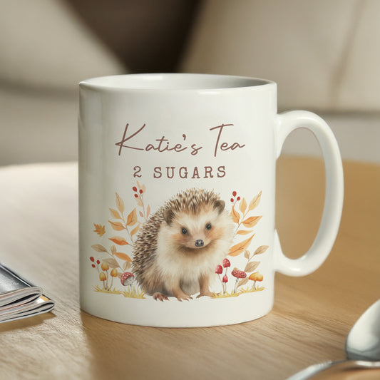 White personalised mug with hedgehog design and text on a wooden surface