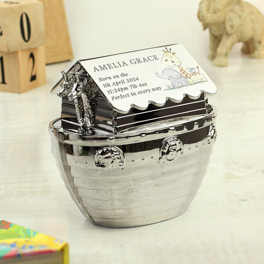 Silver nickel hessian friends Noah's Art money box with birth details. Shown on a shelf with numbered blocks, an elephant and a book.