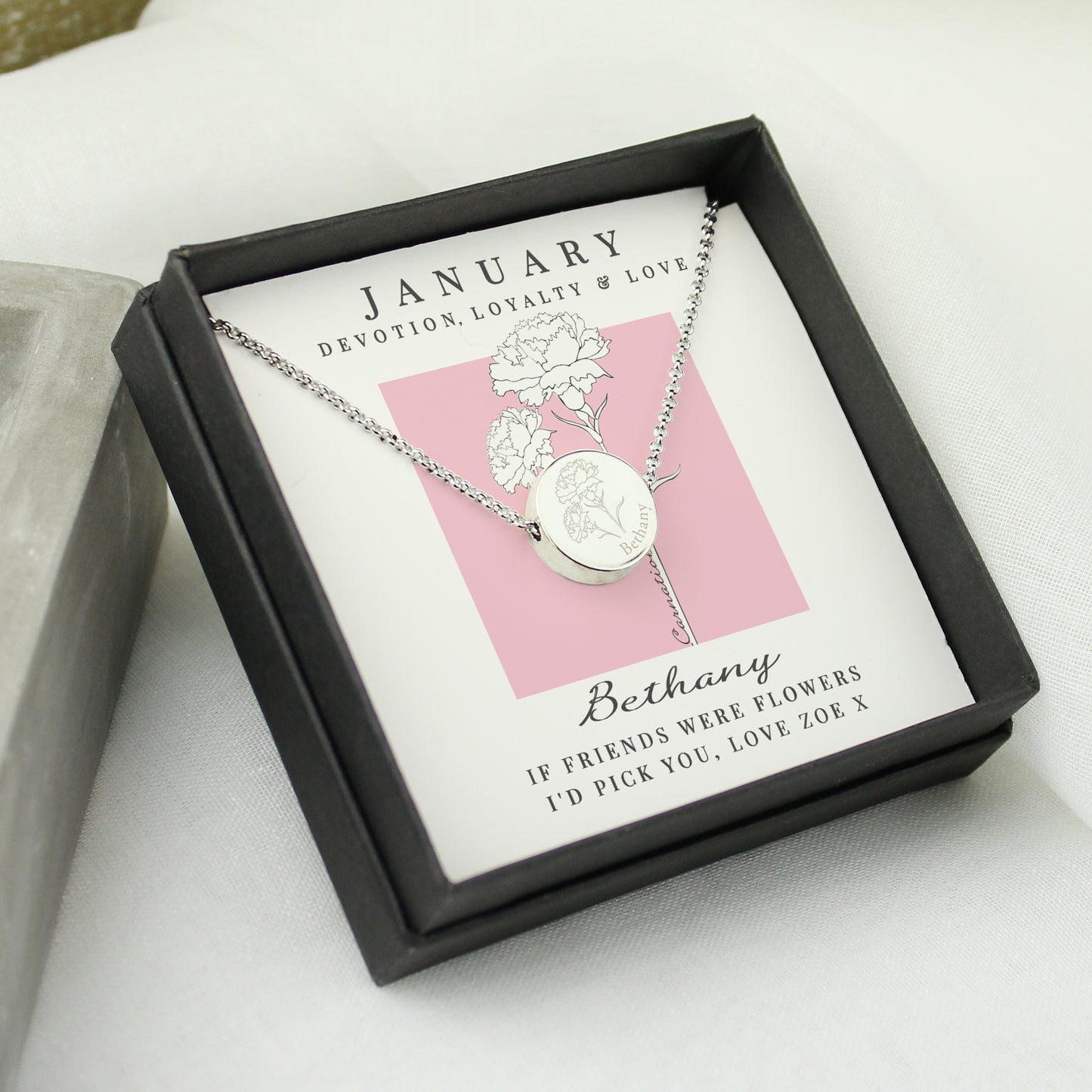 Necklace in a black box featuring 'January' and floral design