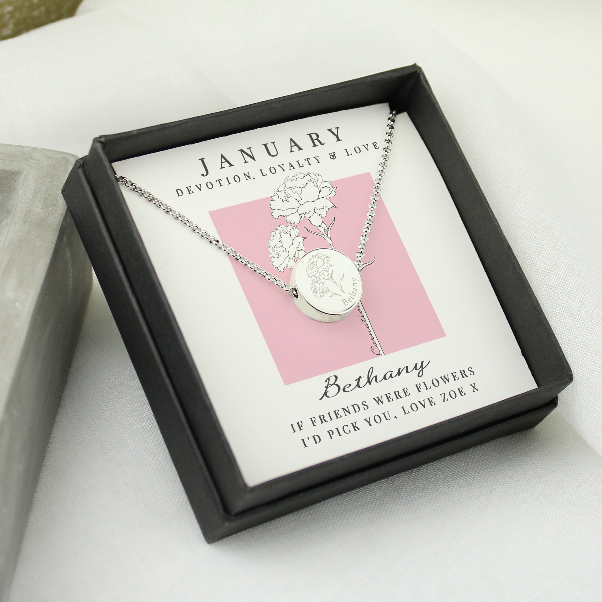 Necklace in a black box featuring 'January' and floral design