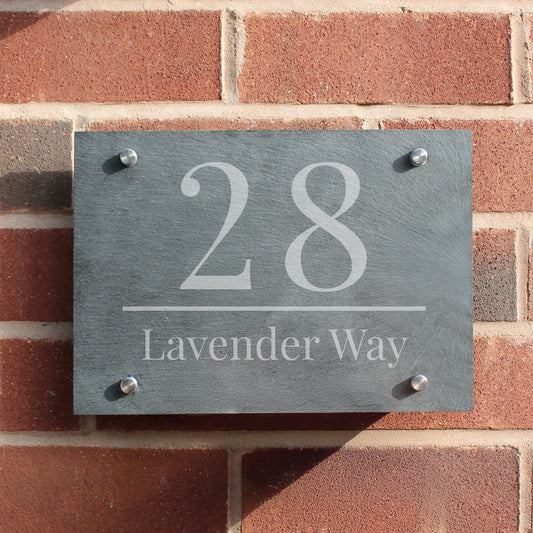 House number sign '28 Lavender Way' on a brick wall