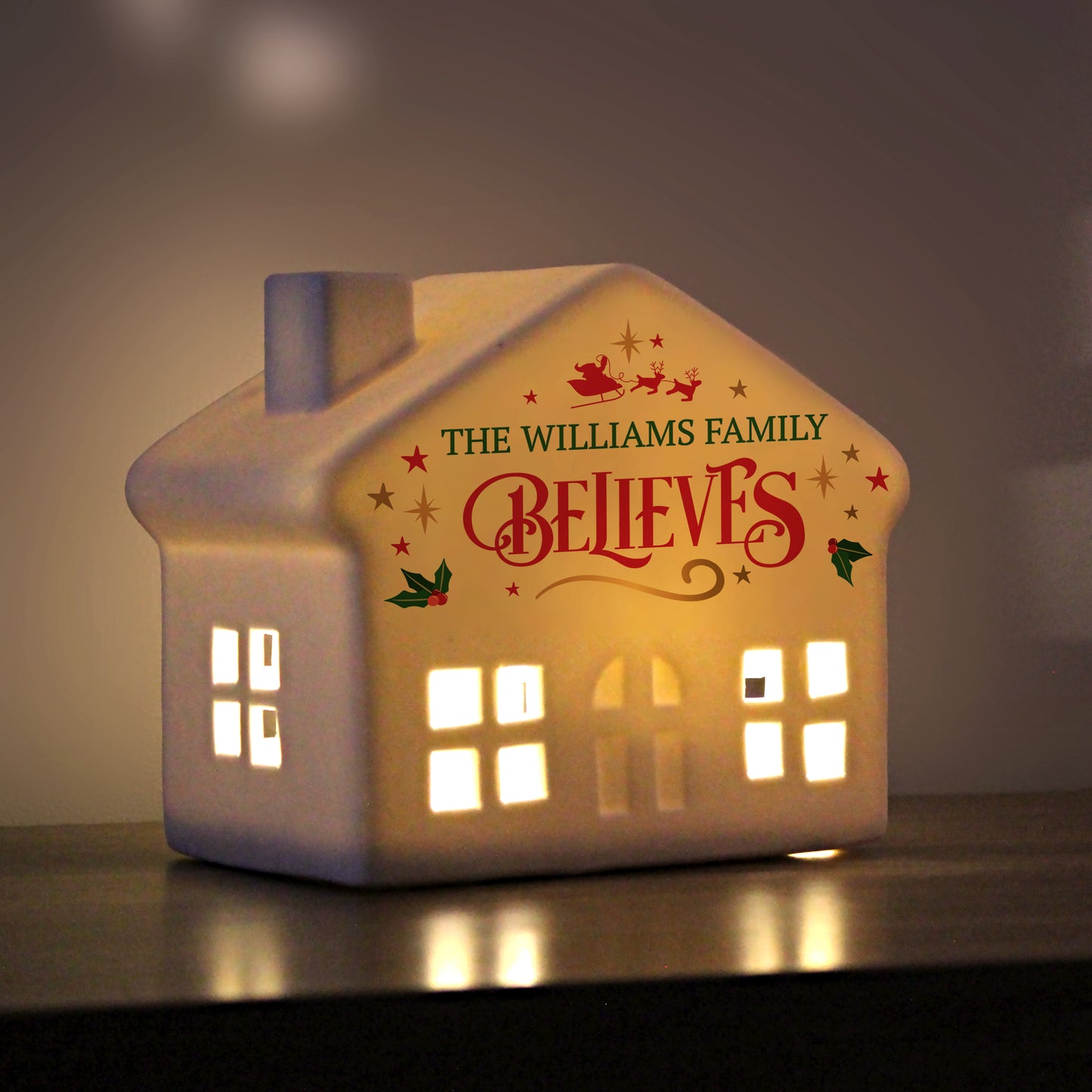 LED Christmas house shown with lights on against a darkened background. Text reads The Williams Family Believes.