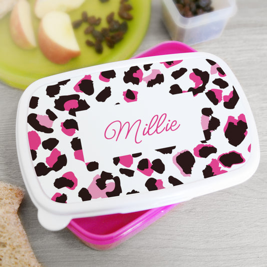 Leopard print lunch box with pink accents on a gray surface