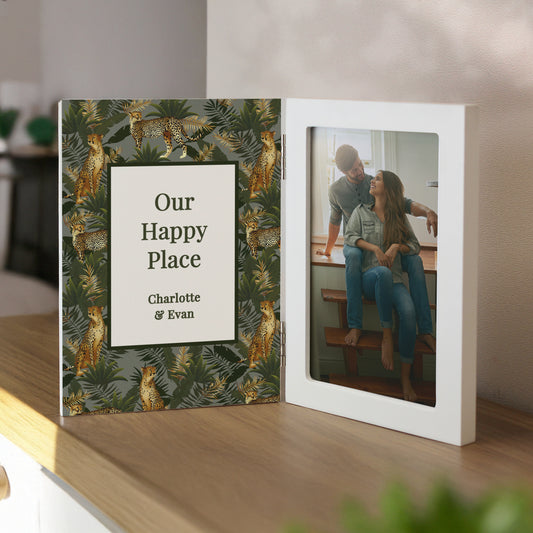 Personalised photo album with jungle leaf design and couple, on a shelf.
