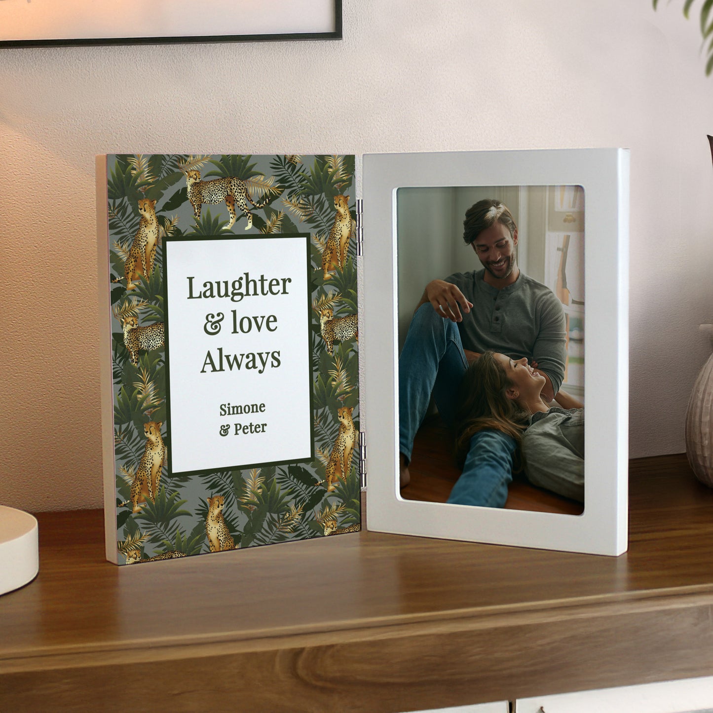 Personalised photo frame with a couple's photo and 'Laughter & Love Always' text on a wooden surface.