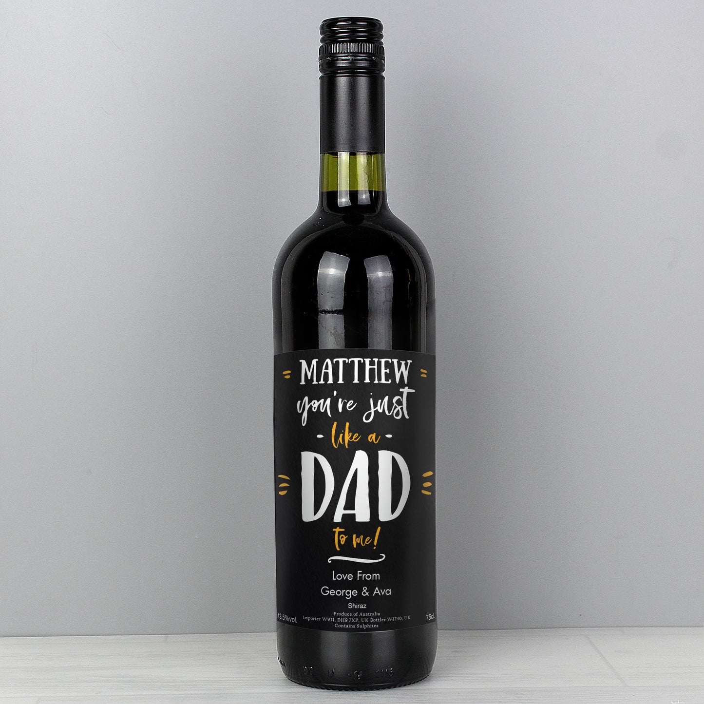 Wine bottle with a personalised label on a grey background