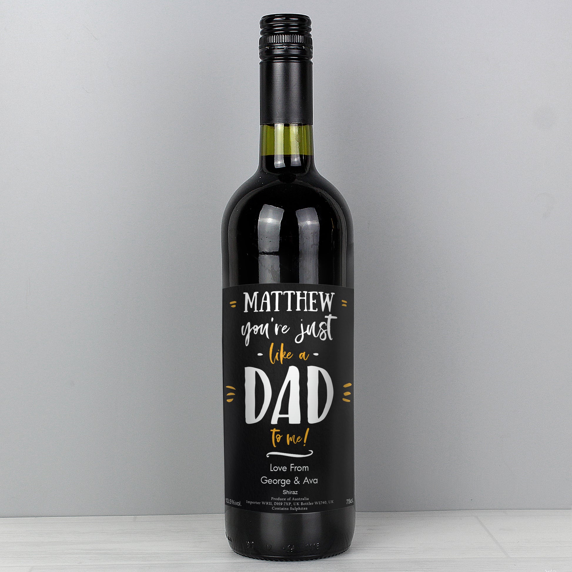 Wine bottle with a personalised label on a grey background