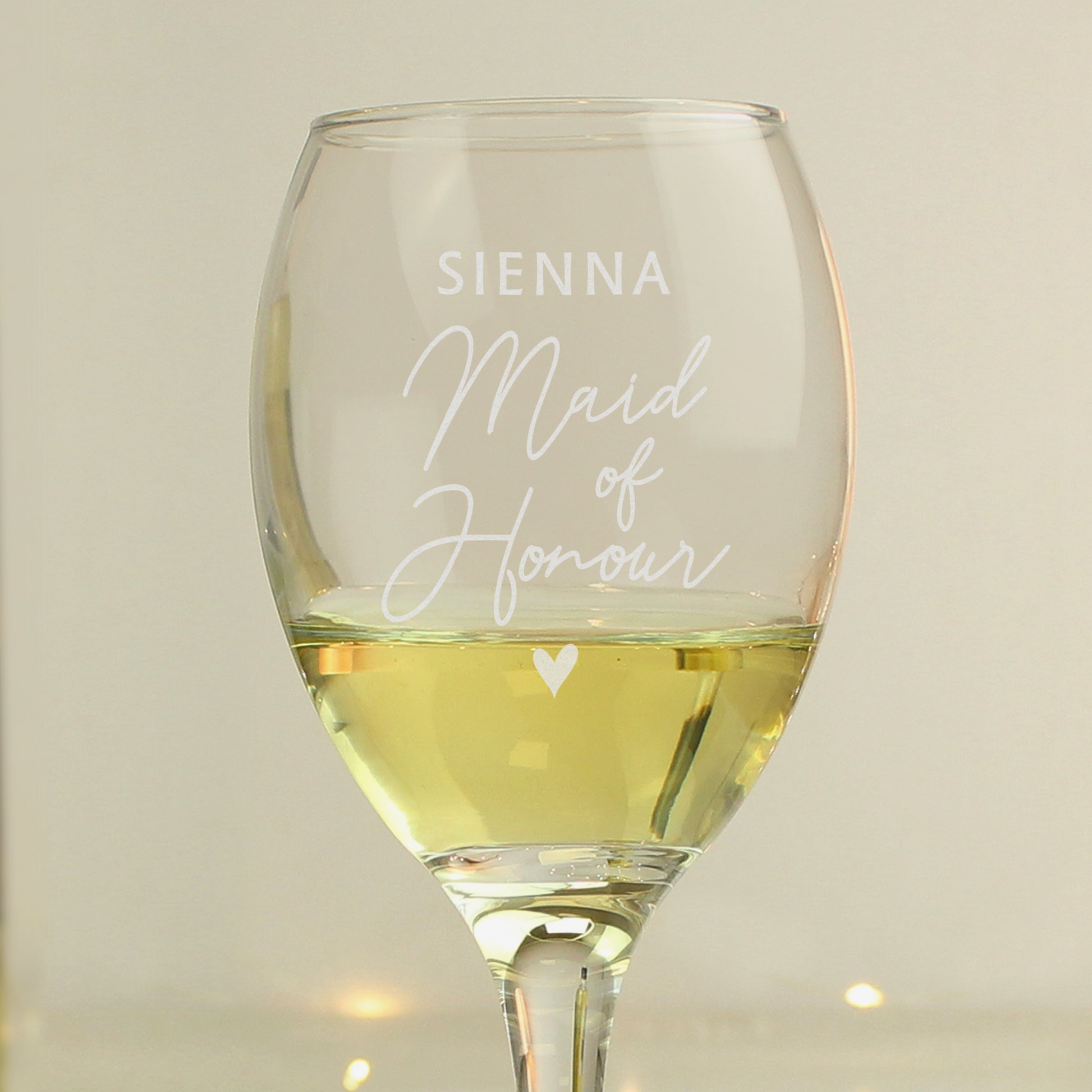 Wine glass with 'Sienna Maid Of Honour' text and a heart symbol on a neutral background
