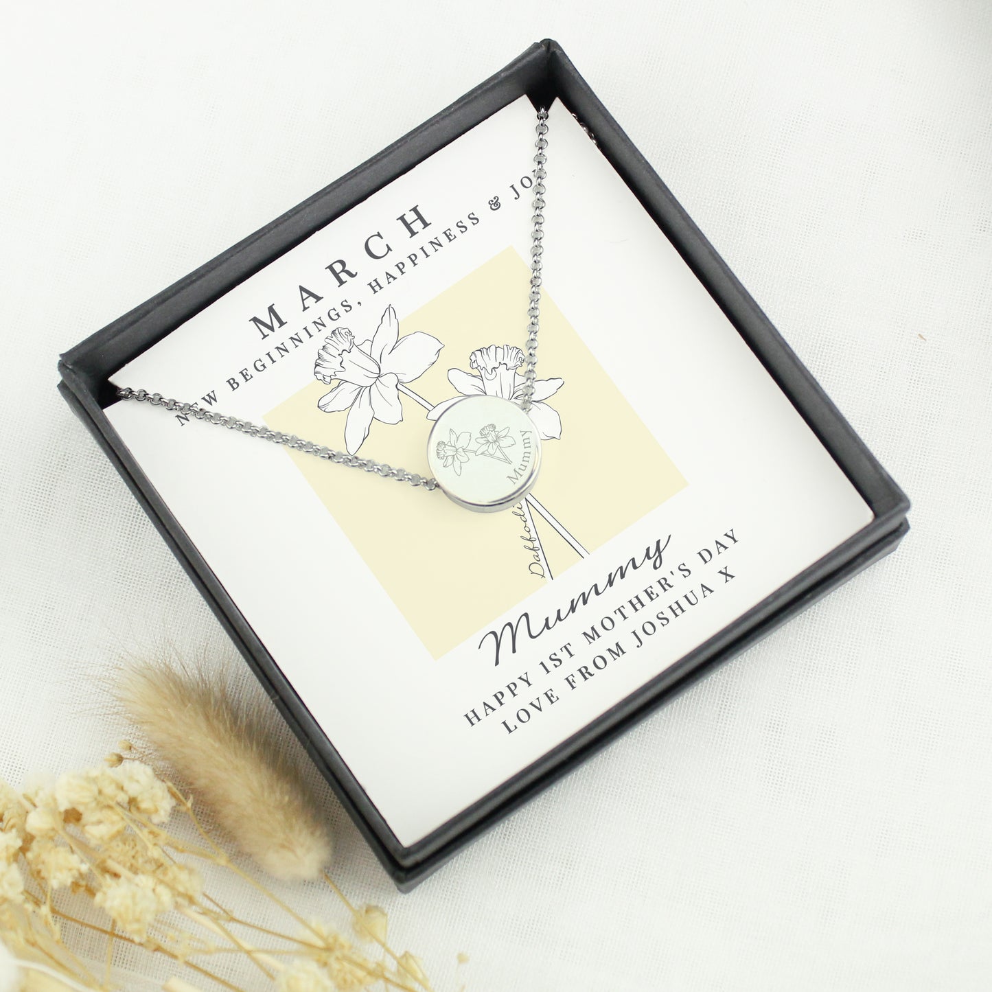 Silver necklace with floral design in a gift box, featuring a personalised message.