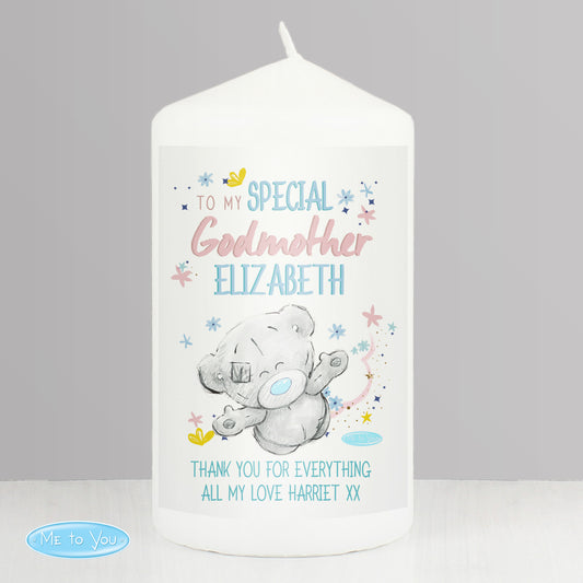 White candle with a teddy bear design and personalised text on a grey background