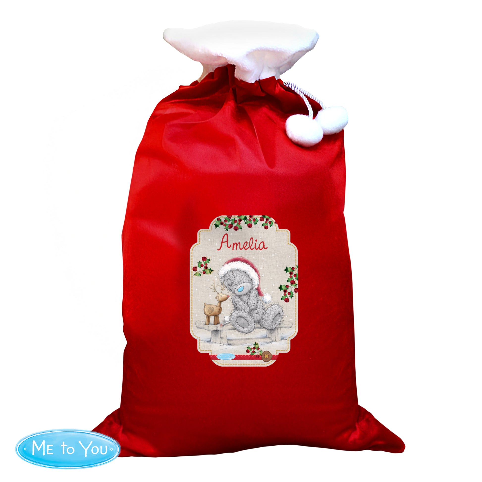 Red Christmas sack with a personalised label featuring a teddy bear and reindeer, on a white background.