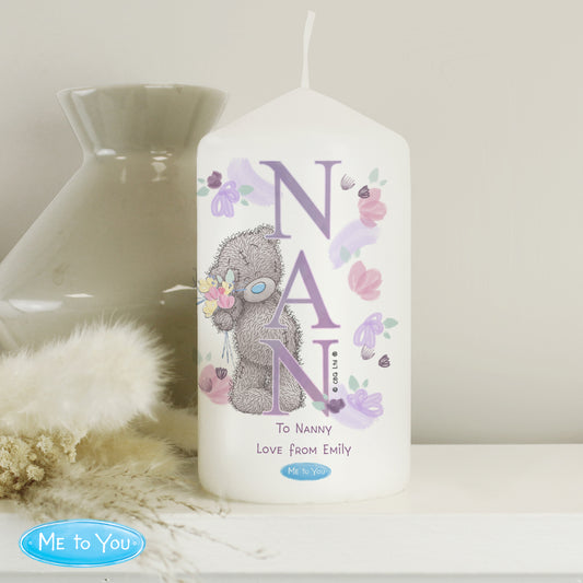 White pillar candle with NAN text and personalised message on a white shelf.