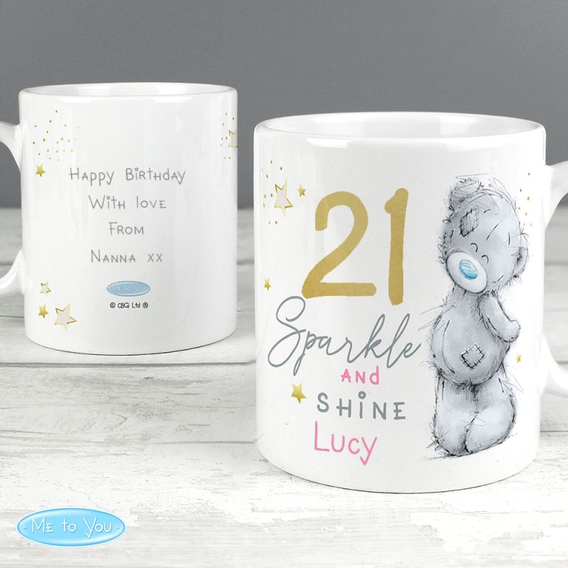 Personalised mug with text and a bear illustration on a wooden surface.