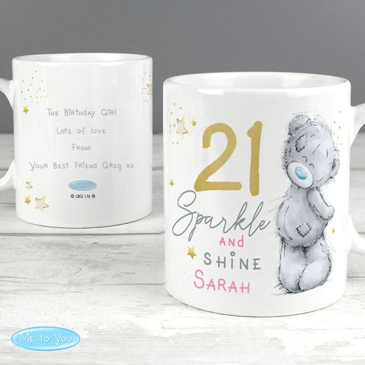Back and front of white mug with personalised text and a bear illustration on a wooden surface.