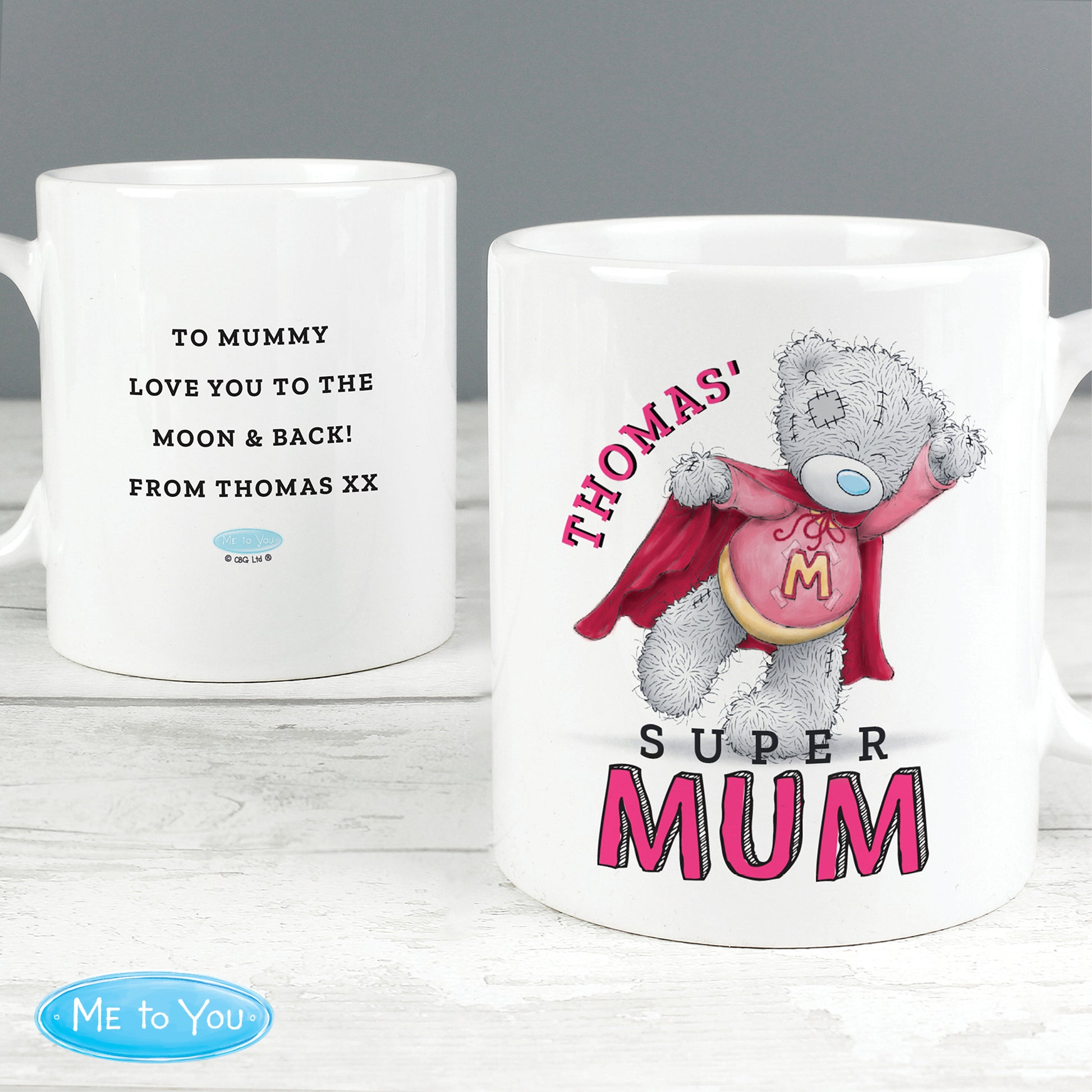 Two images of a mug, one with text and the other featuring a teddy bear with a cape and 'Super Mum' text, on a white surface.