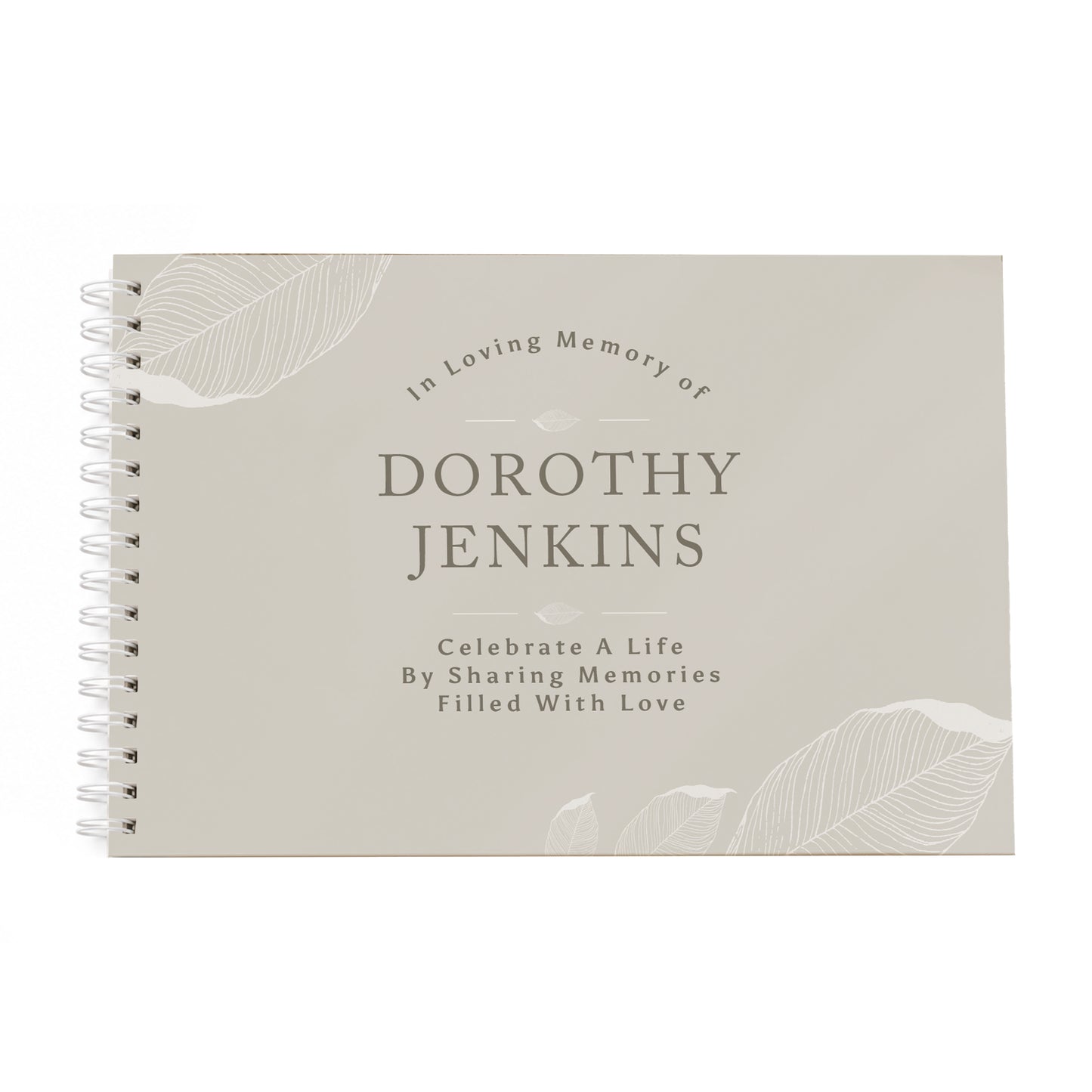 A personalised spiral-bound memory guest book with a light beige cover, featuring the text 'In Loving Memory of DOROTHY JENKINS' and 'Celebrate A Life By Sharing Memories Filled With Love' along with subtle leaf illustrations.