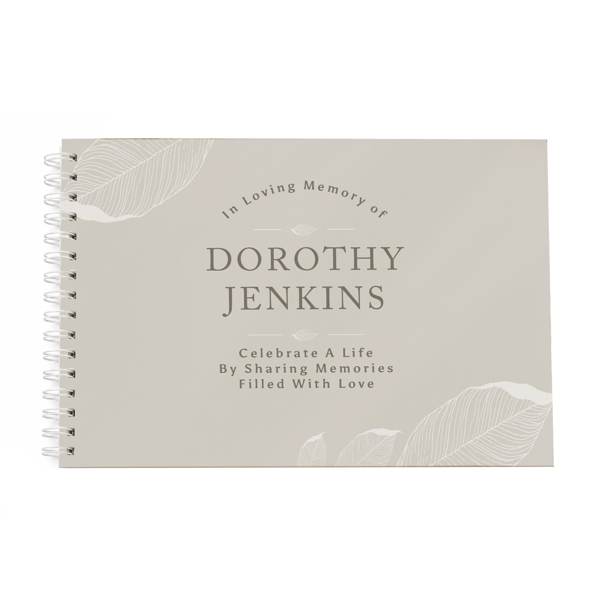 A personalised spiral-bound memory guest book with a light beige cover, featuring the text 'In Loving Memory of DOROTHY JENKINS' and 'Celebrate A Life By Sharing Memories Filled With Love' along with subtle leaf illustrations.