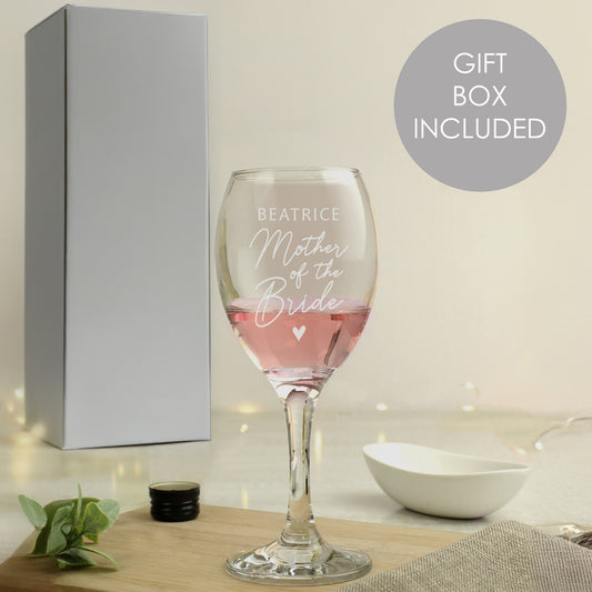 Wine glass with engraved text 'Beatrice Mother of the Bride' in a gift box setting.