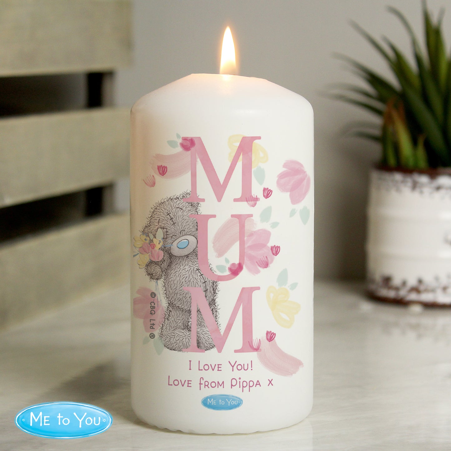Candle with 'MUM' and bear design, featuring 'Me to You' branding, on a neutral background.