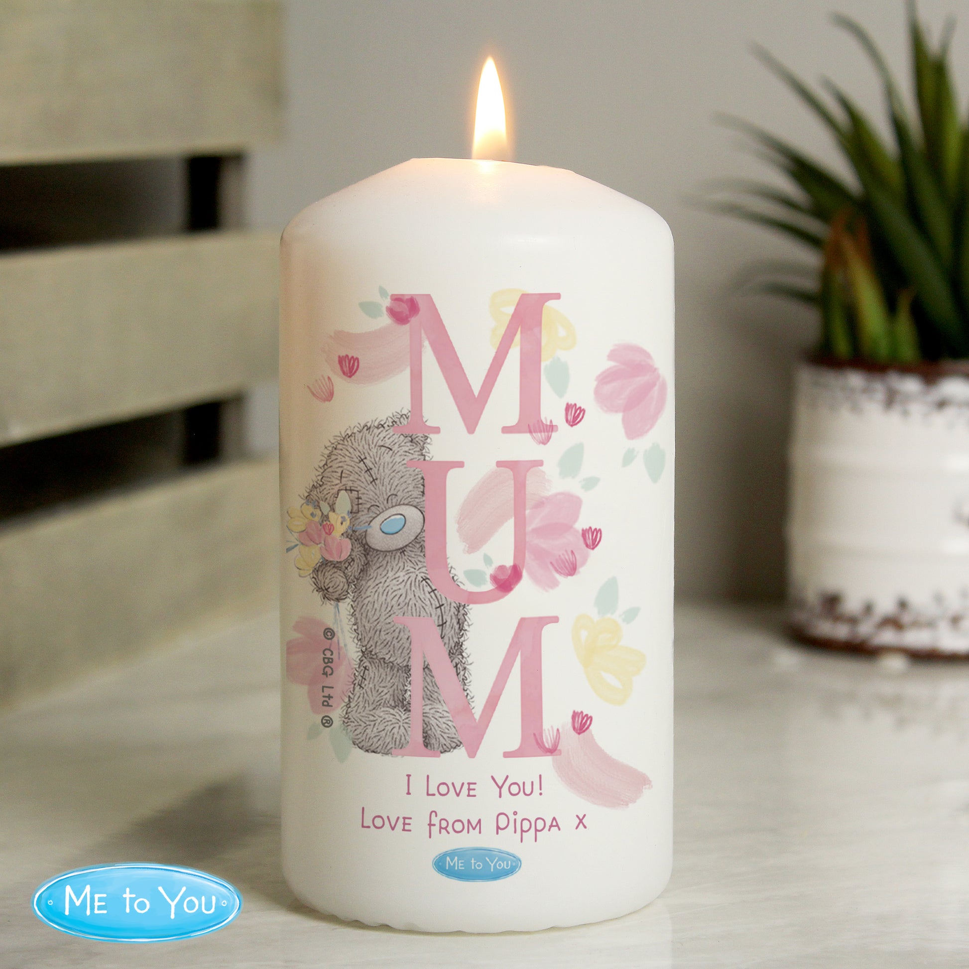 Candle with 'MUM' and bear design, featuring 'Me to You' branding, on a neutral background.