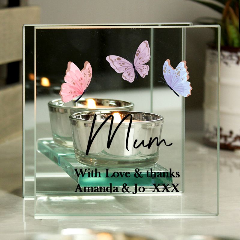 Decorative glass holder with two silver candle holders and pink butterflies, featuring the word 'Mum' and personalised text.