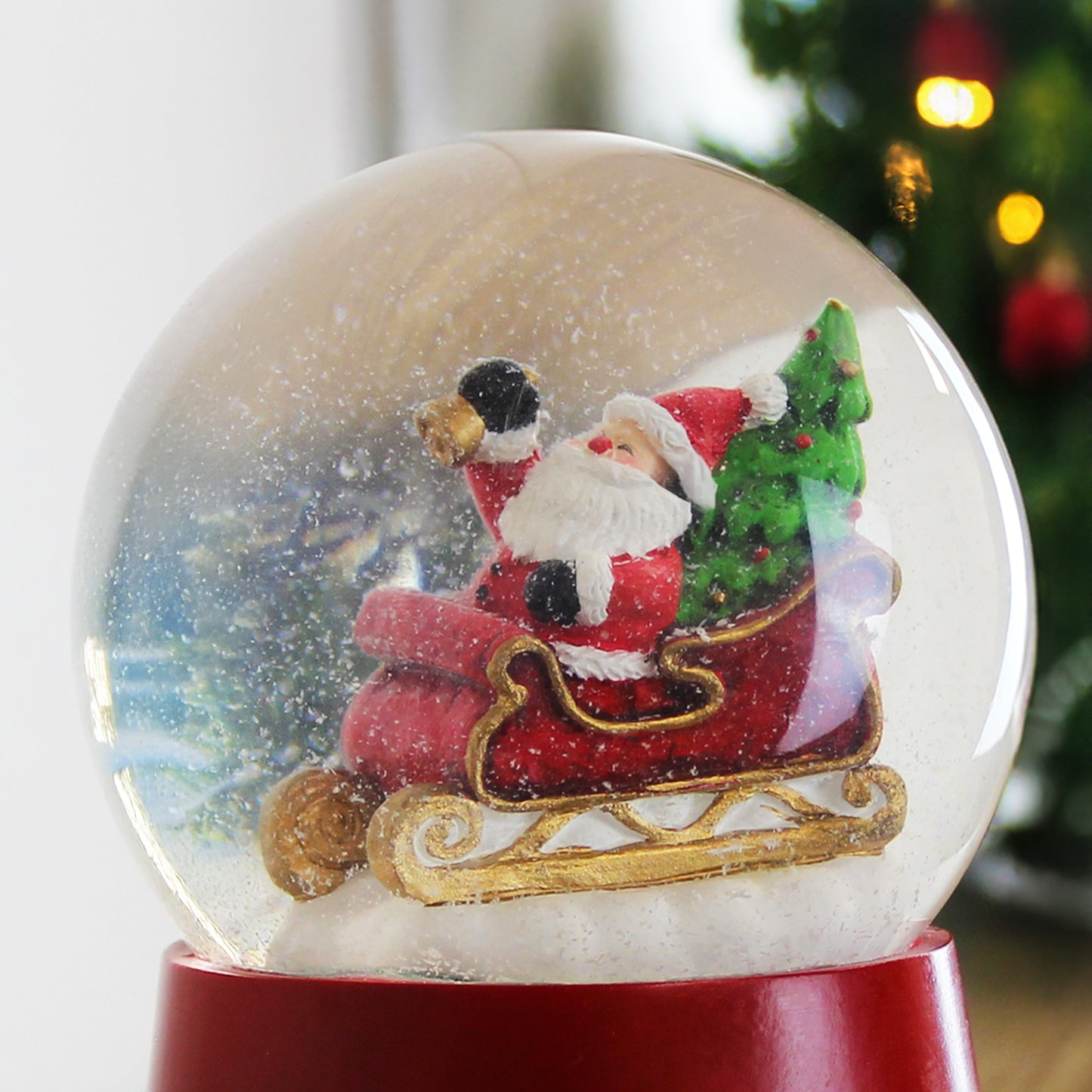 Close up of snow globe showing snow over  Santa on sleigh.