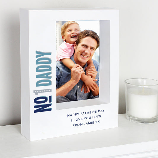 Personalised photo frame with a father and child photo, text 'No 1 Daddy' and 'Happy Father's Day' on a white surface.