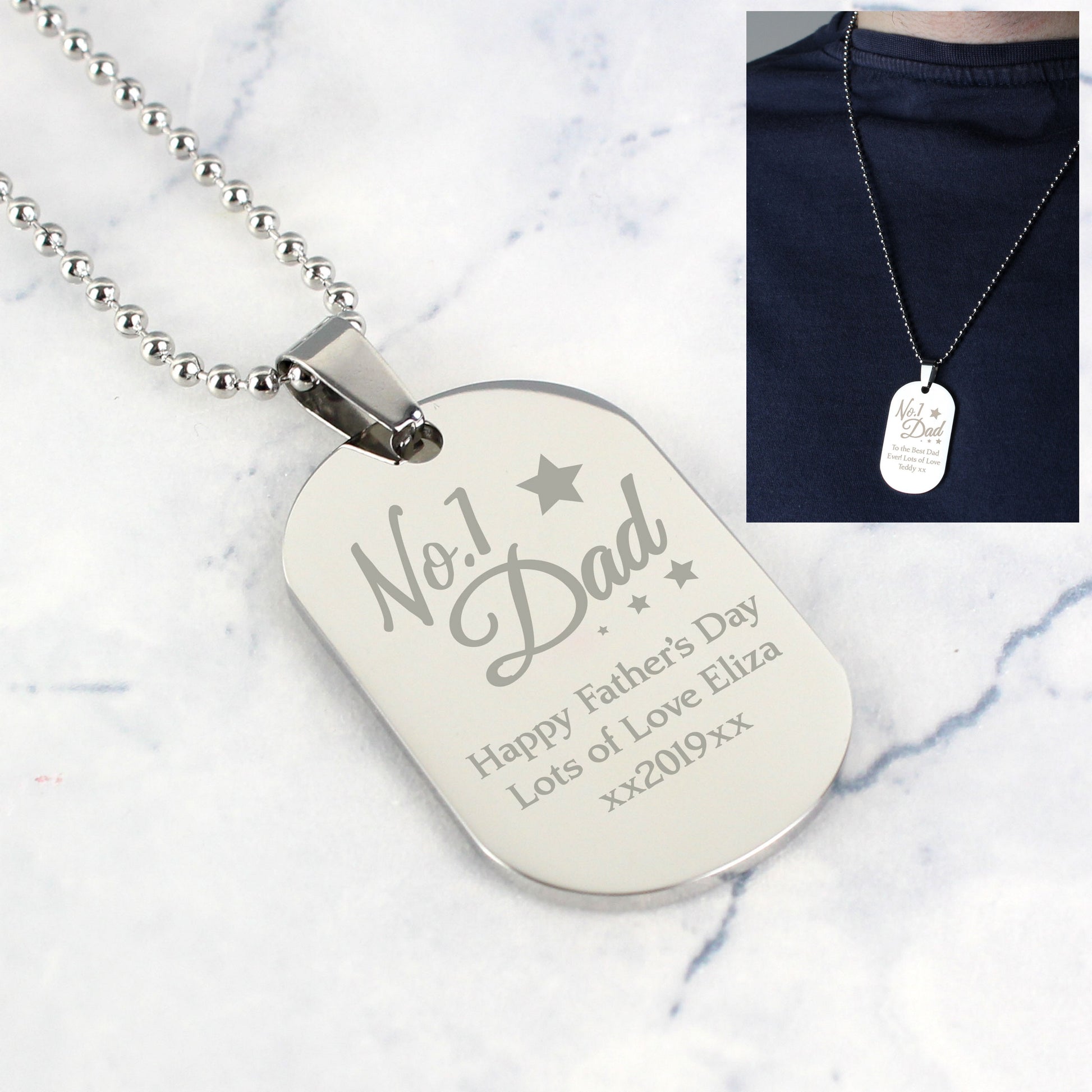 Silver dog tag necklace with engraved text on a white background