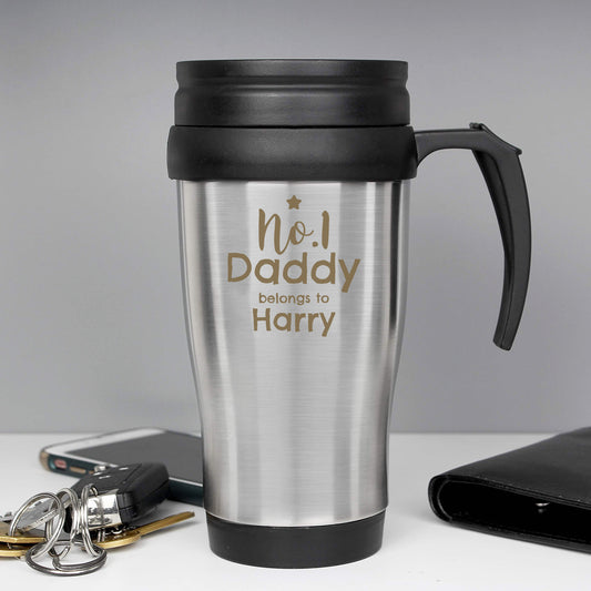 Silver travel mug with black handle and lid, featuring 'No.1 Daddy belongs to Charlotte' text, on a grey background.