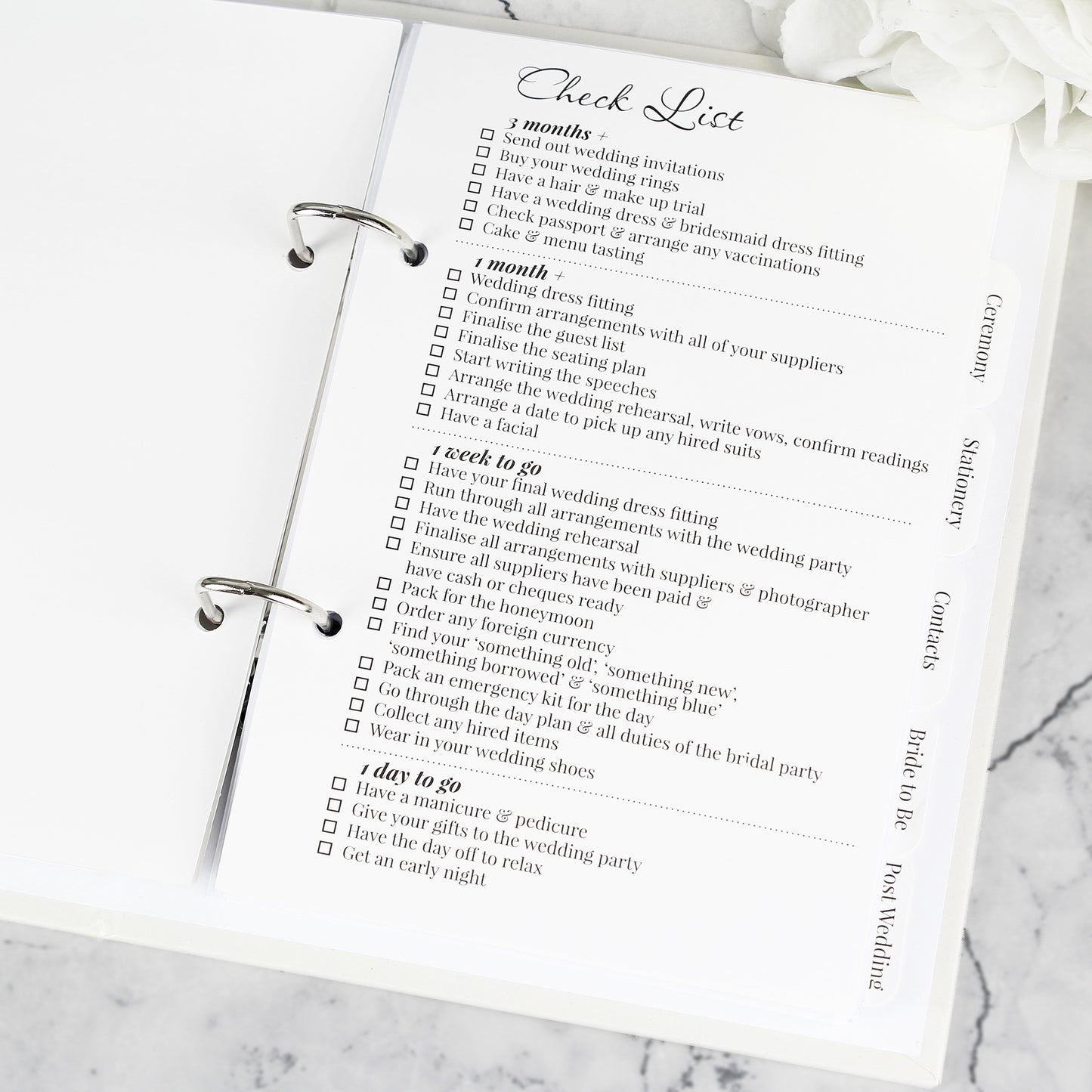 Checklist for wedding planning on a marble surface