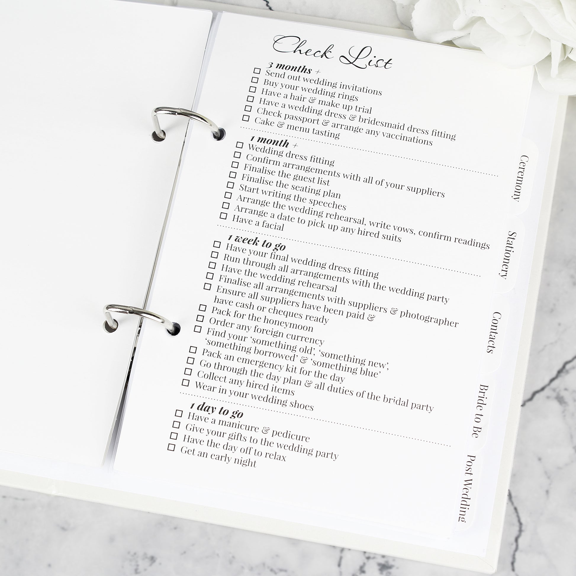 Checklist for wedding planning on a marble surface