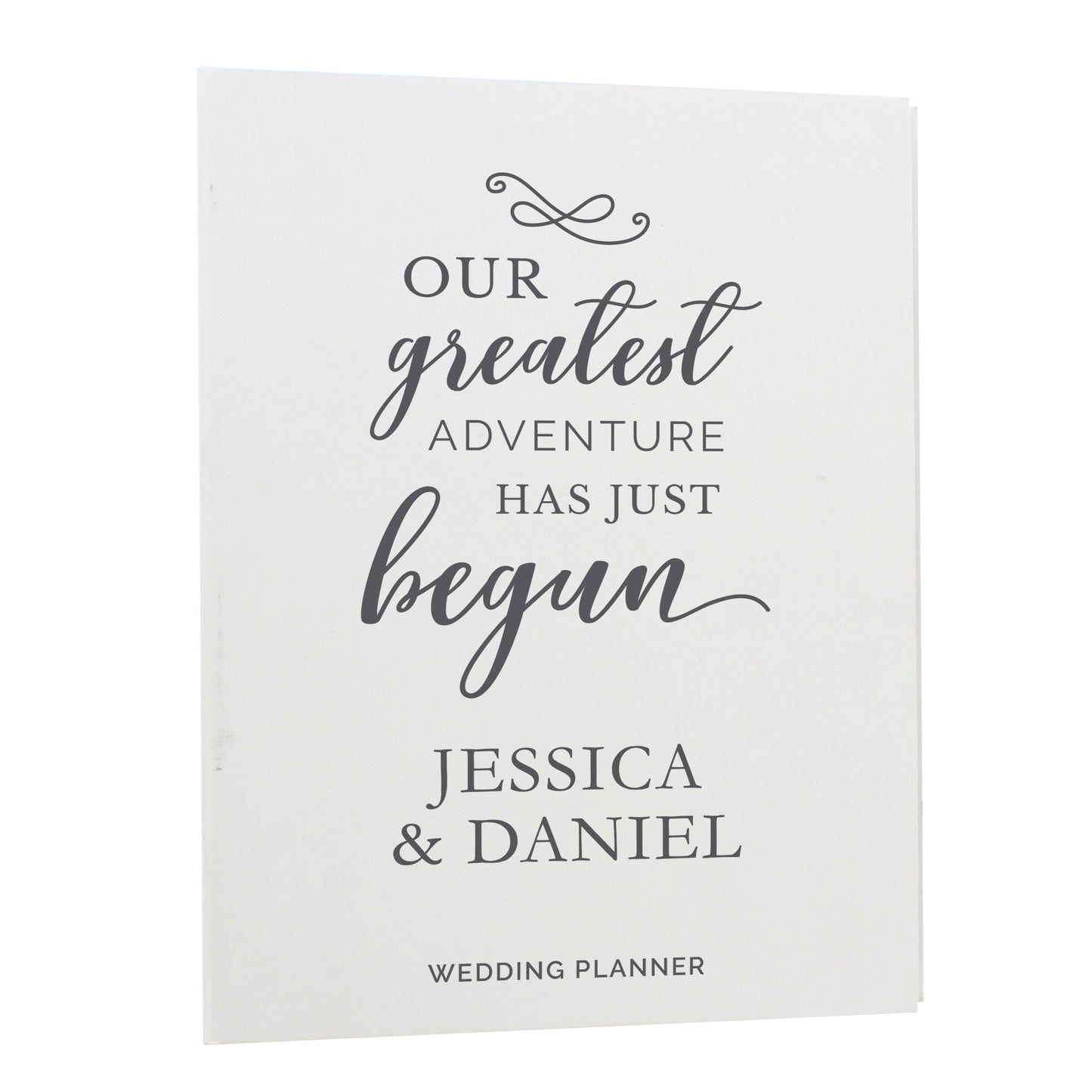 Wedding planner book with 'Our greatest adventure has just begun' text and personalized names on a white background