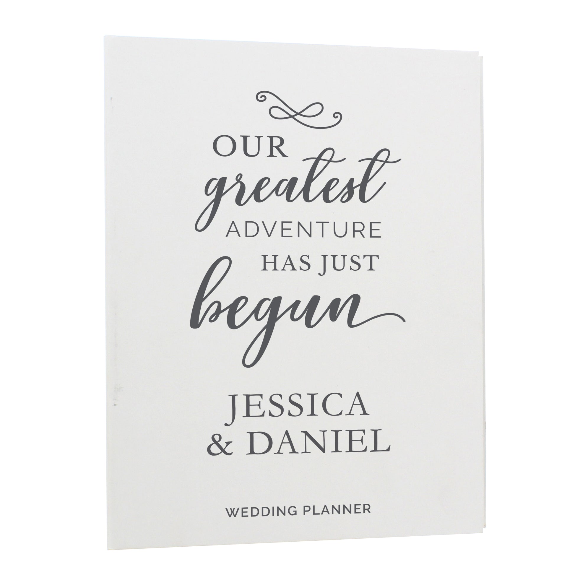 Wedding planner book with 'Our greatest adventure has just begun' text and personalized names on a white background