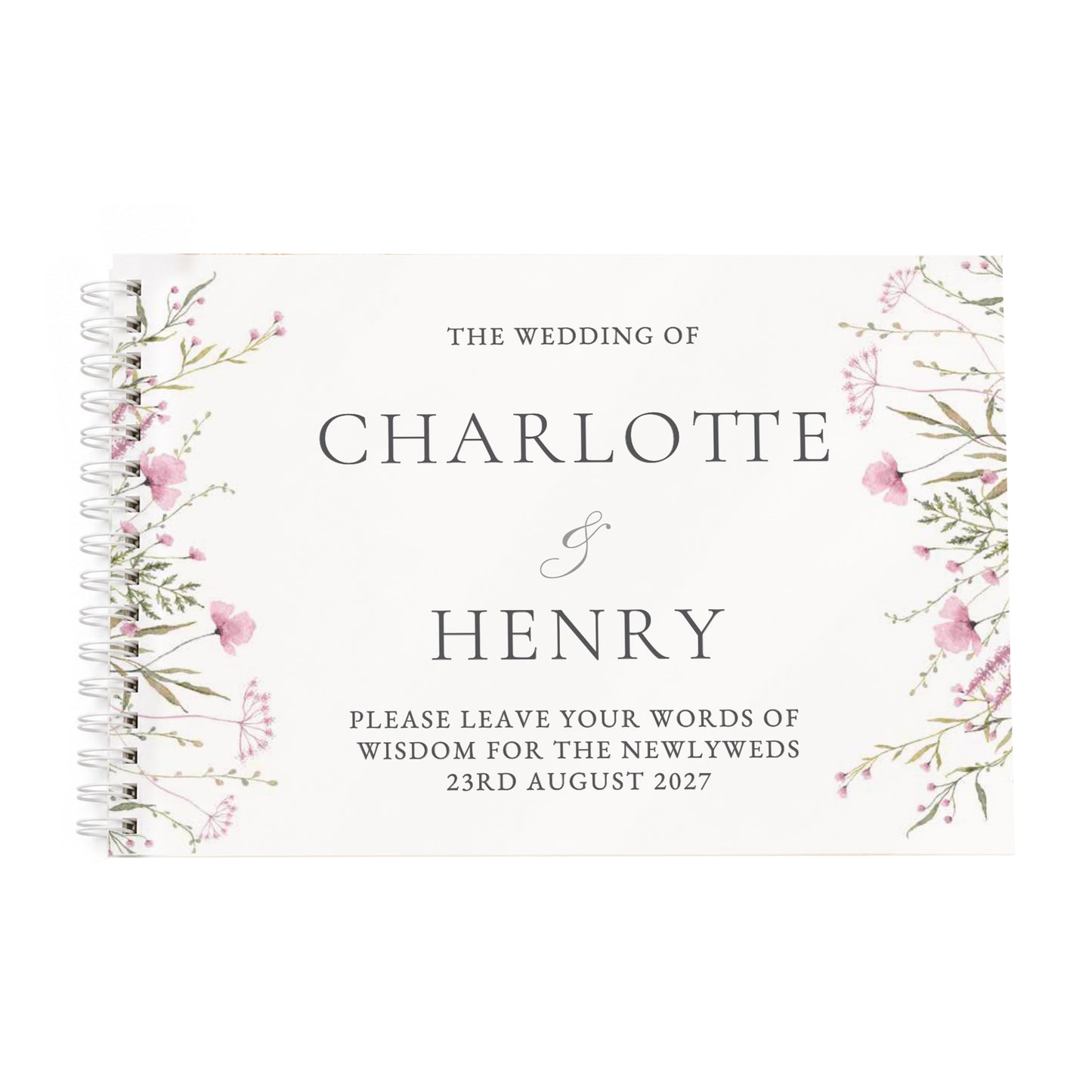 A spiral-bound wedding guest book with a cream cover, featuring delicate pink and green floral illustrations on the sides and elegant black text reading 'The Wedding of Charlotte & Henry' with a placeholder message for the newlyweds.