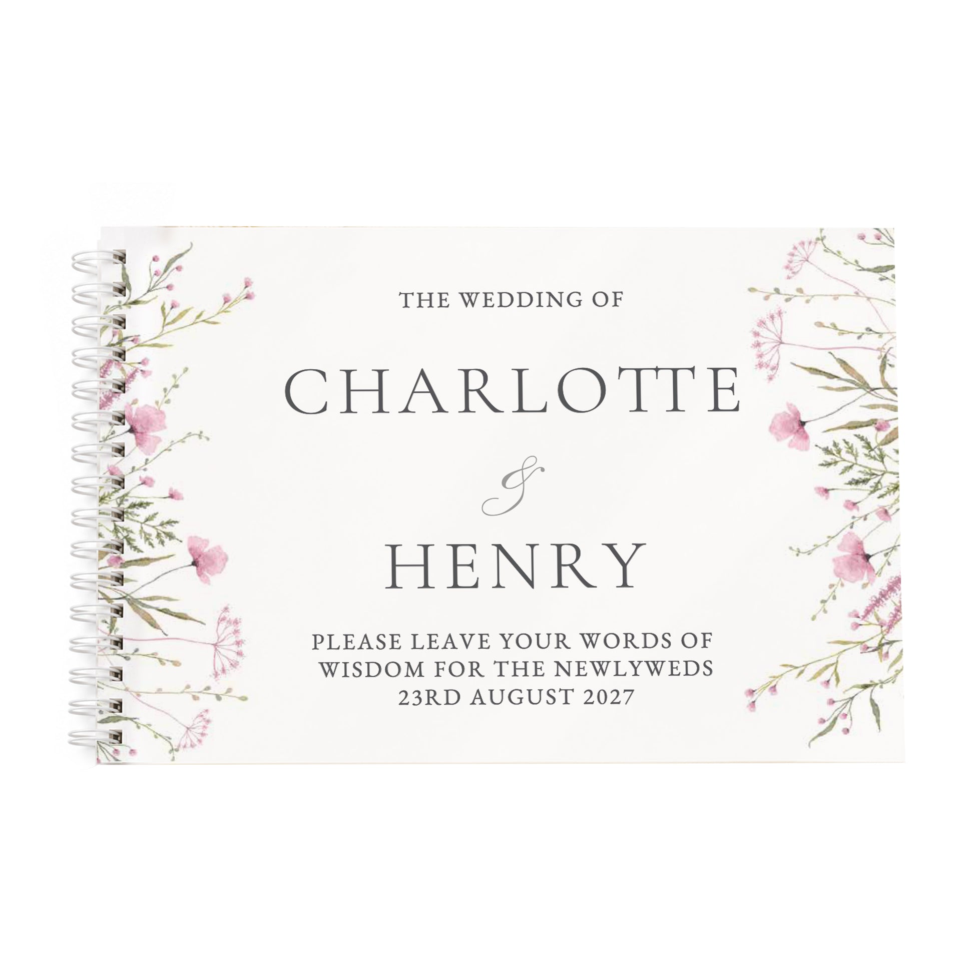 A spiral-bound wedding guest book with a cream cover, featuring delicate pink and green floral illustrations on the sides and elegant black text reading 'The Wedding of Charlotte & Henry' with a placeholder message for the newlyweds.