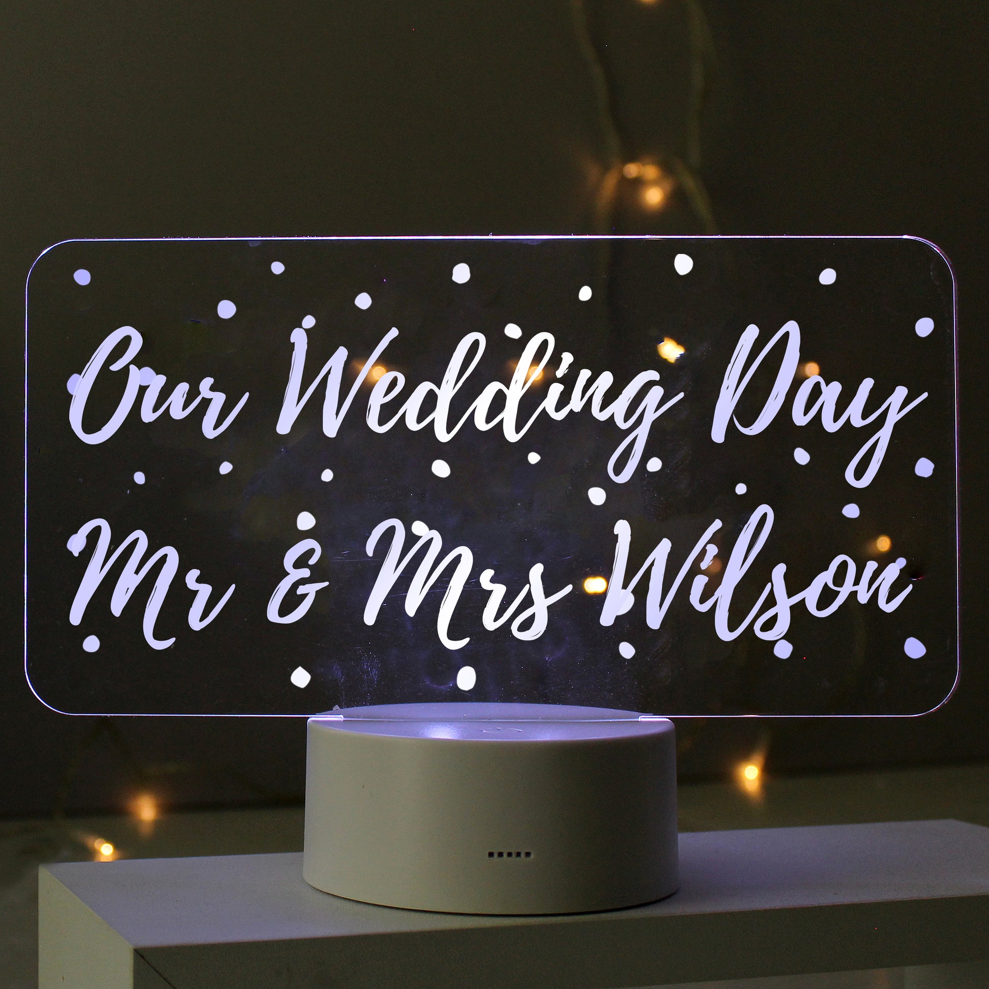 Clear acrylic LED colour changing night light with personalised message. Text reads - Our Wedding Day Mr & Mrs Wilson. On a grey base.