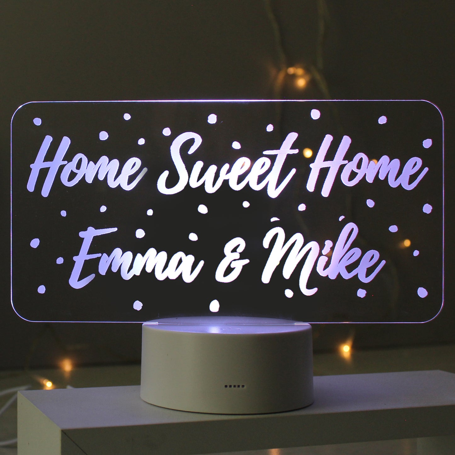 LED sign with 'Home Sweet Home Emma & Mike' text on a dark background