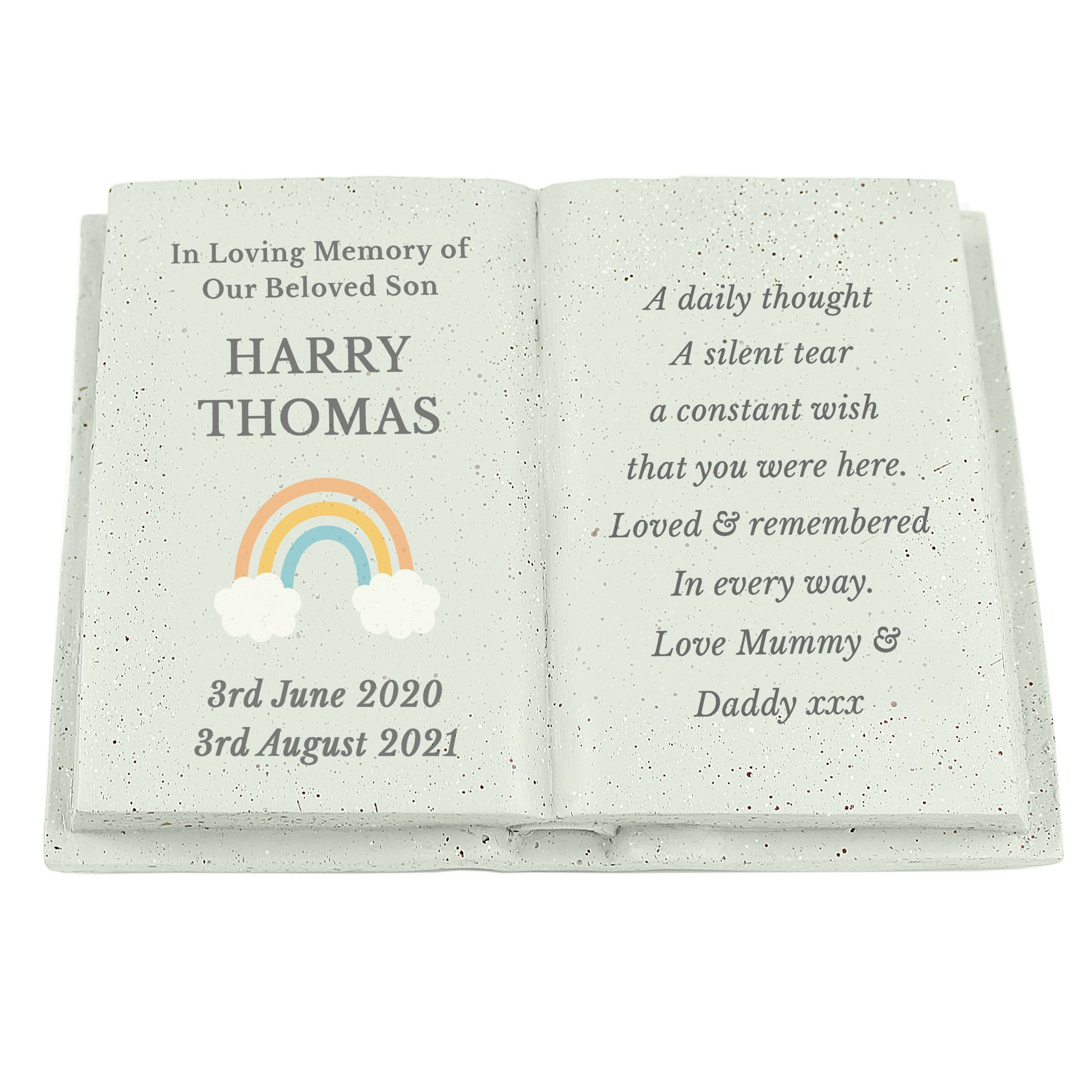 Memorial book with engraved text and rainbow design on a white background