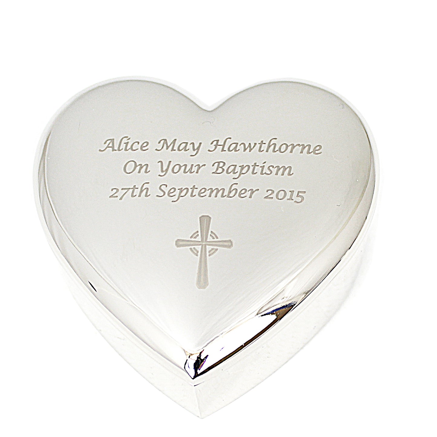 Heart-shaped silver trinket box with engraved text and cross design on a white background