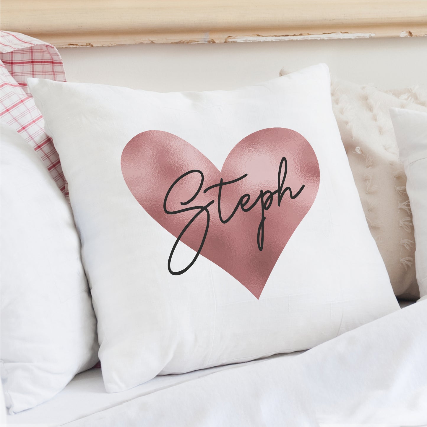 Cushion in white with rose gold heart design and personalised name.
