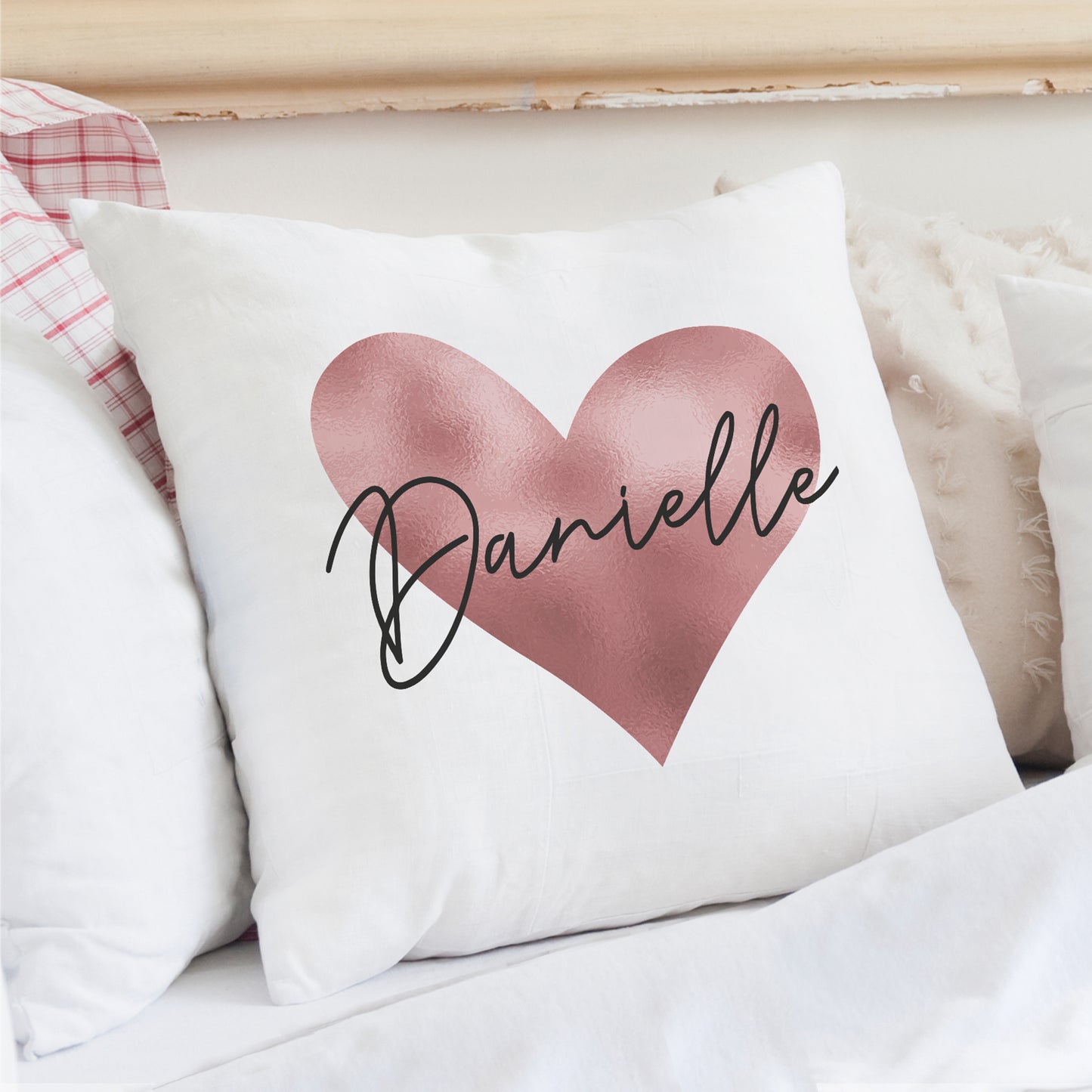 Cushion in white with rose gold heart design and personalised name.