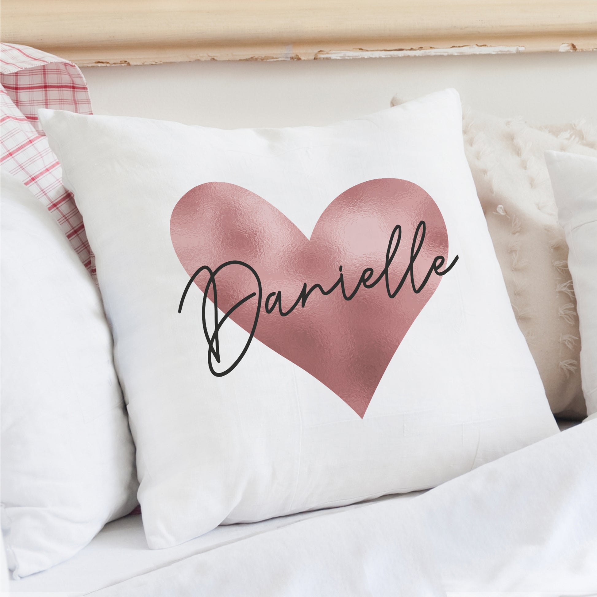 Cushion in white with rose gold heart design and personalised name.