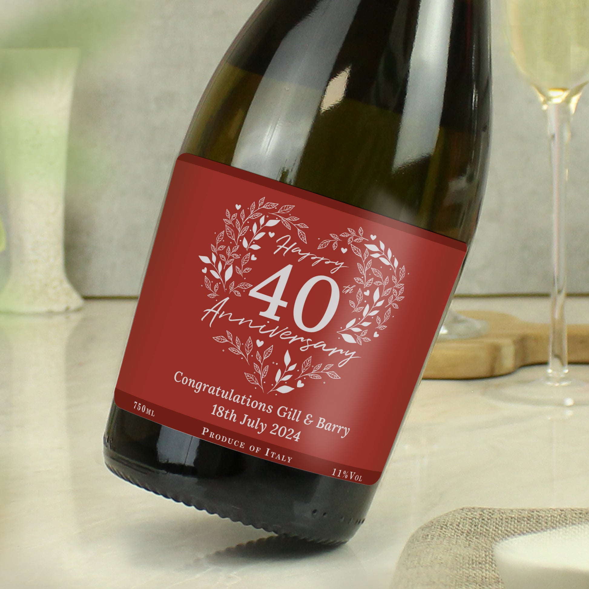 Wine bottle with a red 'Happy 40 Anniversary' label on a table.