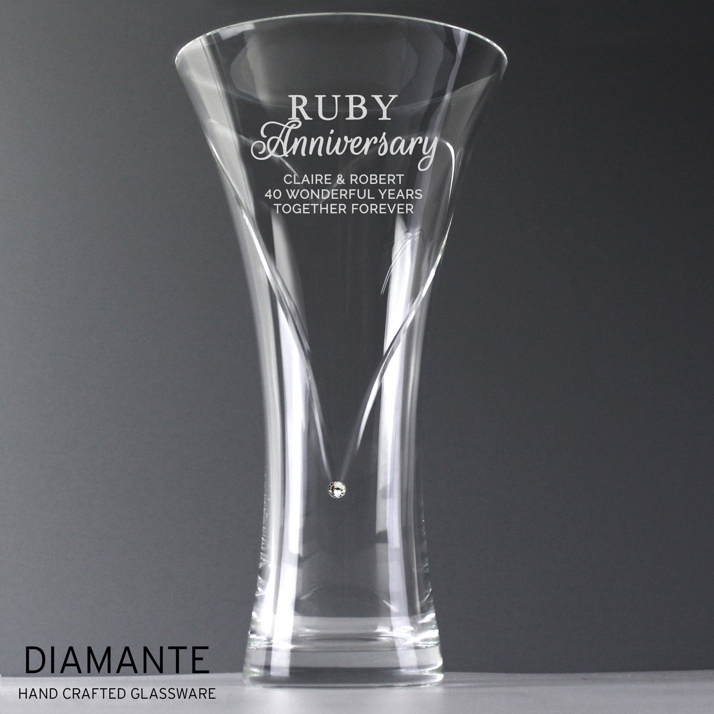 Clear glass vase with engraved Ruby Anniversary text on a grey background