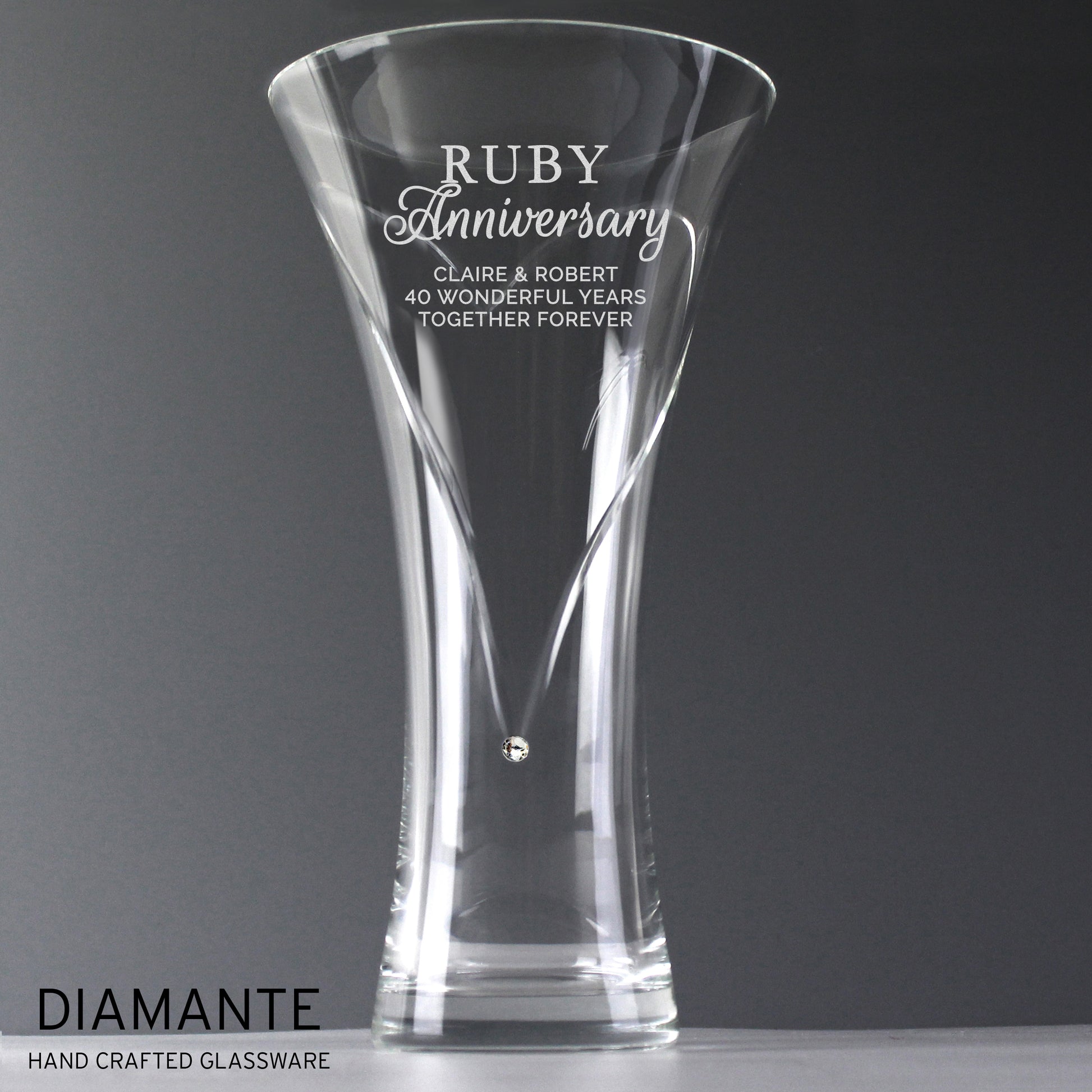 Clear glass vase with engraved Ruby Anniversary text on a grey background